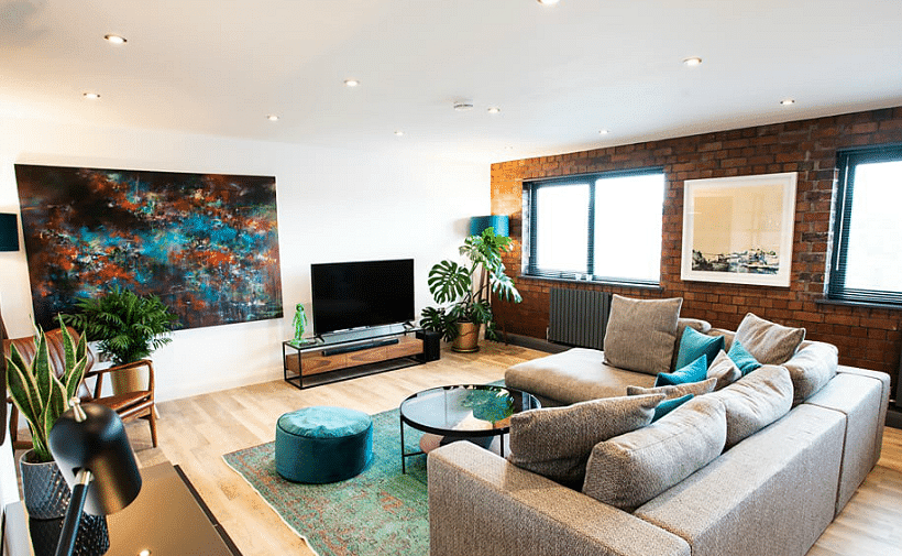 Modern living room, wood finished flooring, with art images shown on the wall